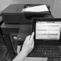 woman press on printer touchscreen to scan documents